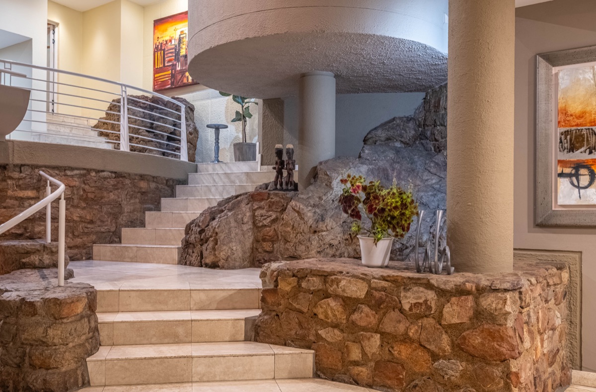 Cliffside interior staircase built around exposed natural rock