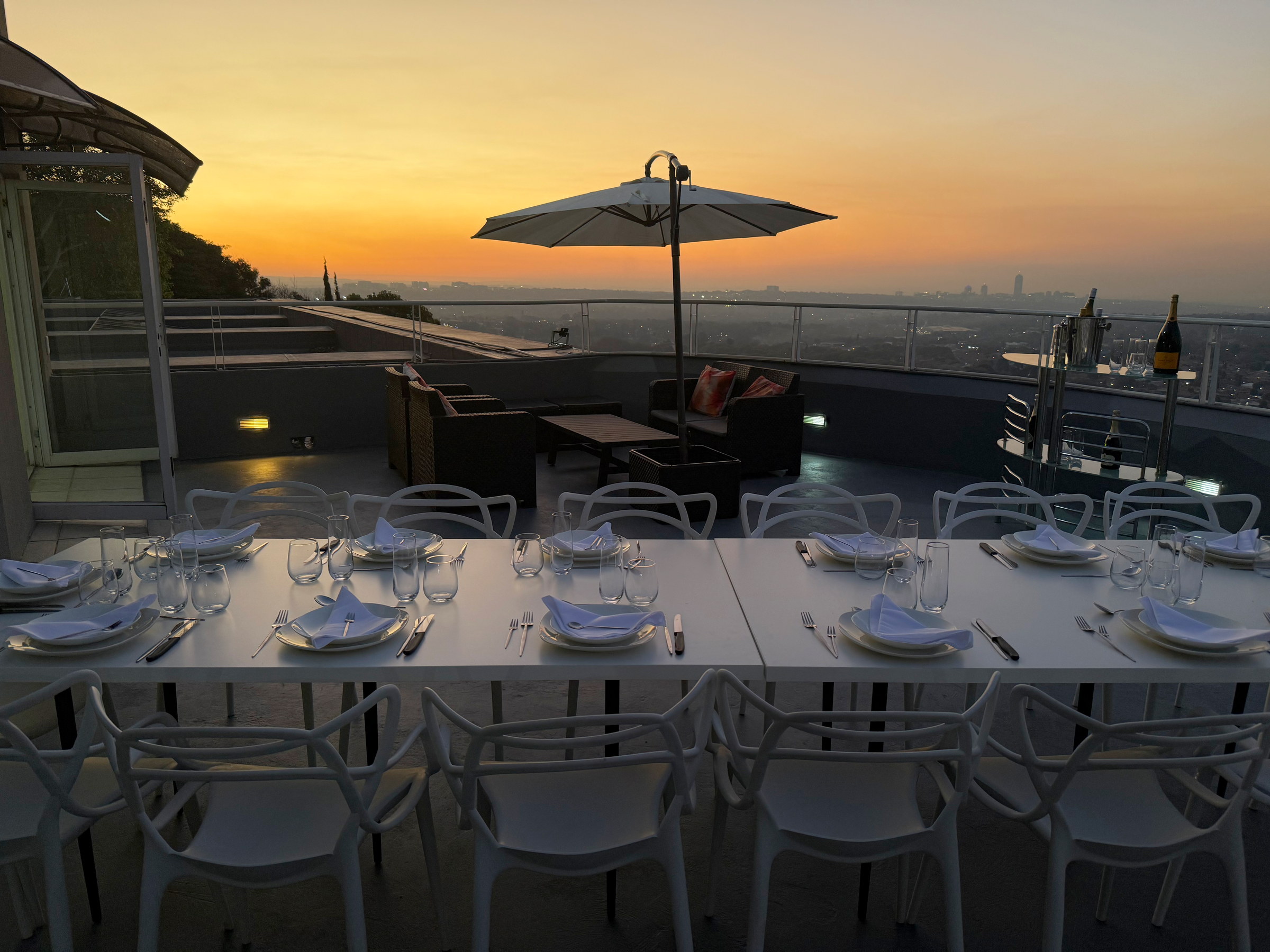 Long dining tables set across the Horizons deck at dusk