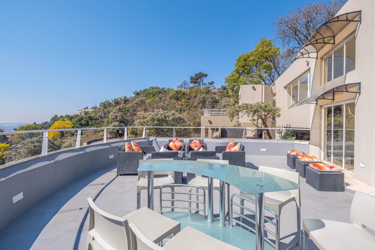 Open Horizons rooftop deck with lounge furniture and Johannesburg views