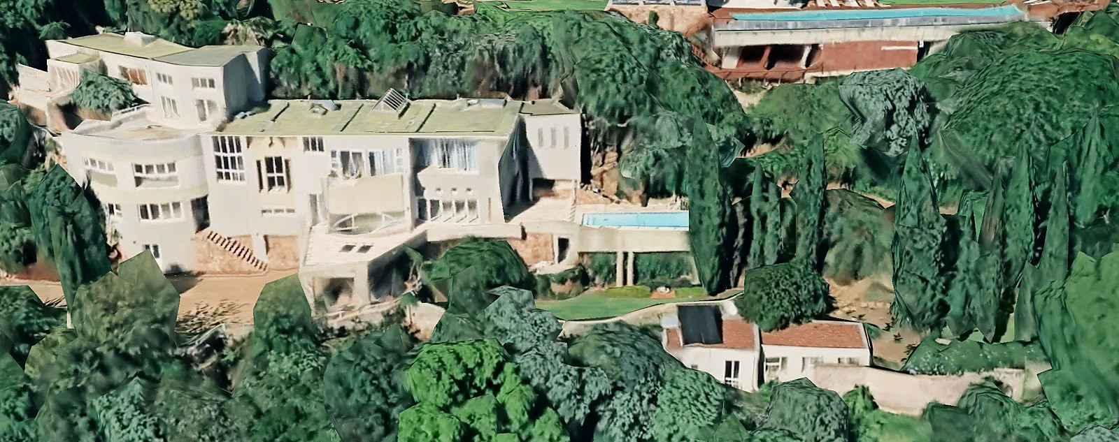 Aerial overview of Venue With A View showing the hillside buildings, pool and surrounding garden terraces